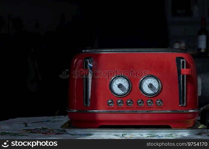 Red retro styled toaster for breakfast. Toaster in vintage style, Electric stainless steel toaster, Space for text, Selective focus.