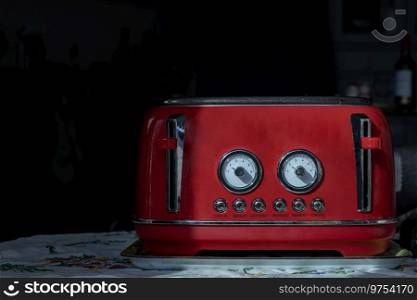 Red retro styled toaster for breakfast. Toaster in vintage style, Electric stainless steel toaster, Space for text, Selective focus.