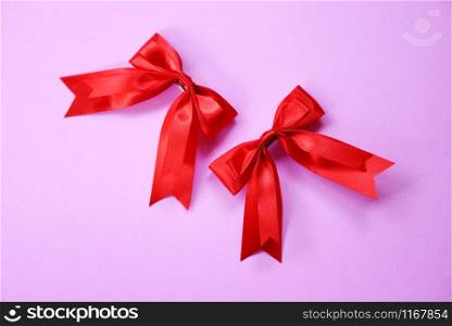 Red ribbon bow on pink background / Two gift bow hairpin perfect holiday handmade