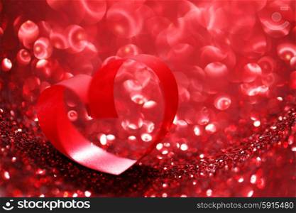 Red ribbon heart on glitter background, Valentines day concept