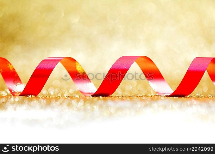 Red ribbon on golden background