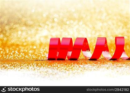 Red ribbon on golden background