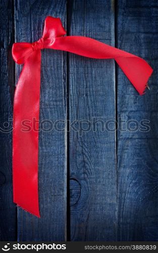 red ribbon on wooden background, festive background
