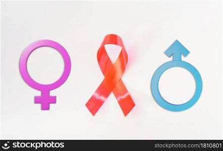 Red Ribbon Support HIV, AIDS and Male and female gender signson pink background and copy space for use, activism and relationship of sex concept