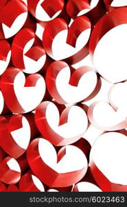 Red ribbons shaped as hearts on white background