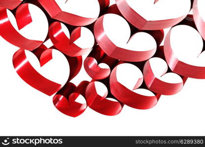 Red ribbons shaped as hearts on white background