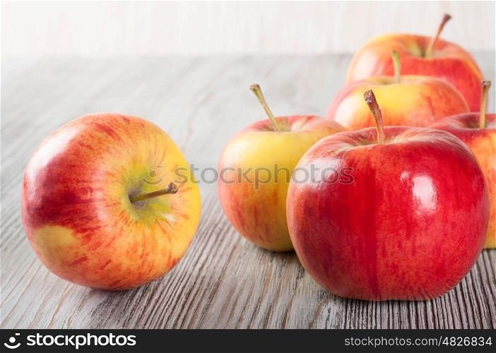 Red ripe apples on a wooden table