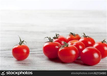 Red ripe cherry tomatoes on a wooden table