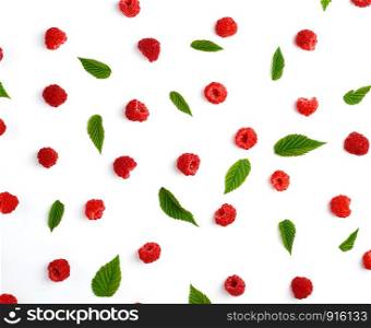 red ripe raspberries and green leaves scattered on a white background, top view, summer backdrop, flat lay