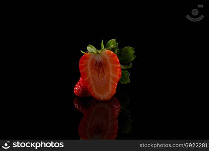 Red ripe strawberry fruits on a dark background