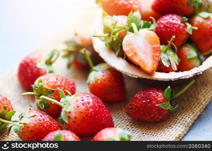 Red ripe strawberry on wooden background, Fresh strawberries on sack