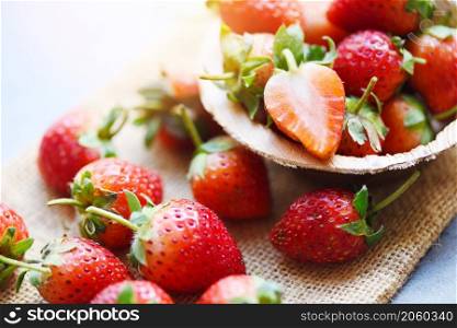Red ripe strawberry on wooden background, Fresh strawberries on sack