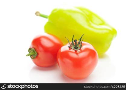 red ripe tomatoes and peppers isolated on white