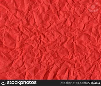 Red rippled paper background useful for Christmas greeting card. Red Christmas background