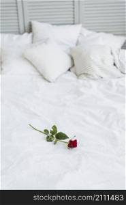 red rose bed with white linen