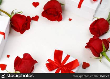 Red rose flowers gifts hearts and gifts composition isolated on white background top view with copy space. Valentine&rsquo;s day, birthday, wedding, Mother&rsquo;s day concept. Copy space. Red roses hearts gifts card