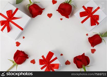 Red rose flowers hearts and gifts composition on white background top view with copy space. Valentine&rsquo;s day, birthday, wedding, Mother&rsquo;s day concept. Copy space. Red roses hearts gifts card