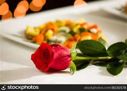 Red rose for a romantic dinner at the restaurant. Red rose for a romantic dinner