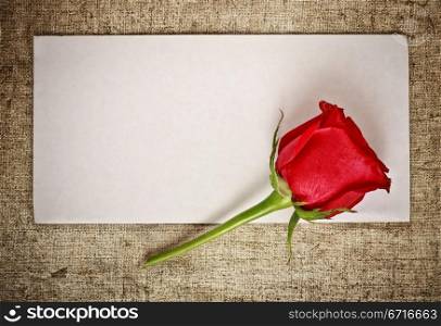 red rose on old canvas and blank envelope, template