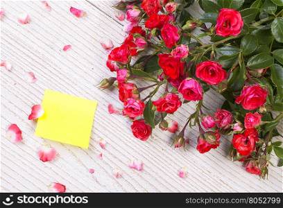 red rose on wooden table background with paper as a copy space, Romantic floral theme