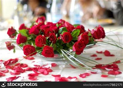 red rose petals on the table newlyweds