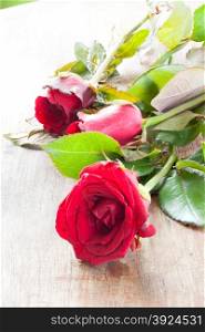 Red Rose. Rose is placed on a wooden table.