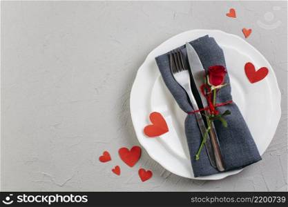 red rose with cutlery light plate