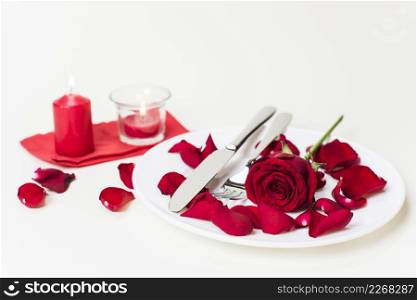 red rose with cutlery plate