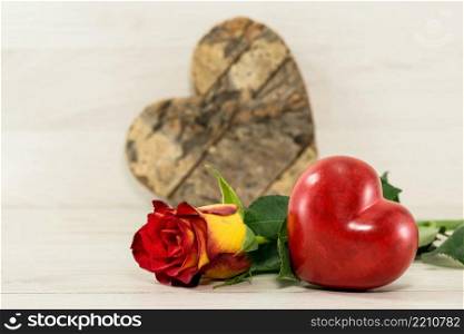 red rose with heart shape on wooden background for kothers day or valentines. valentines red heart shape and rose