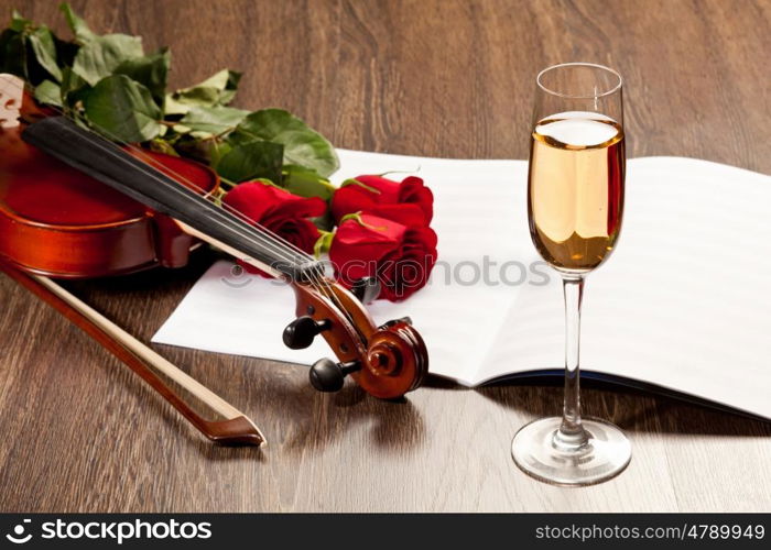 Red roses and a violin. Red roses and a violin on the table