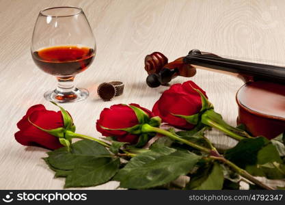 Red roses and a violin. Red roses and a violin on the table