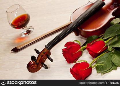 Red roses and a violin. Red roses and a violin on the table