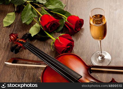 Red roses and a violin. Red roses and a violin on the table