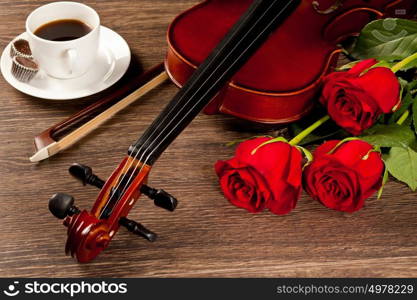 Red roses and a violin. Red roses and a violin on the table