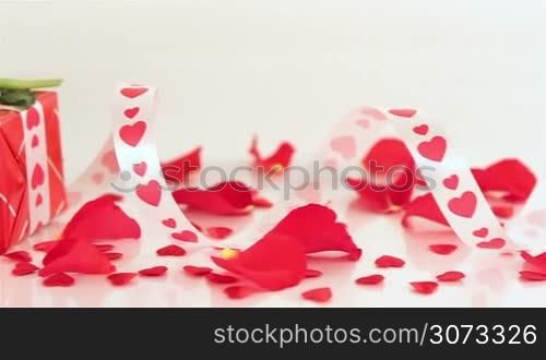 Red roses and chocolate candies with candles for Valentine&acute;s Day. Love and romance concept.