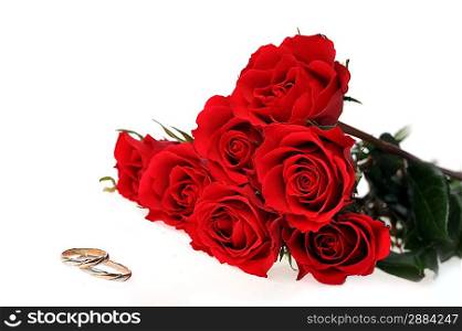 red roses and ring isolated on white