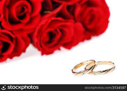 red roses and ring isolated on white