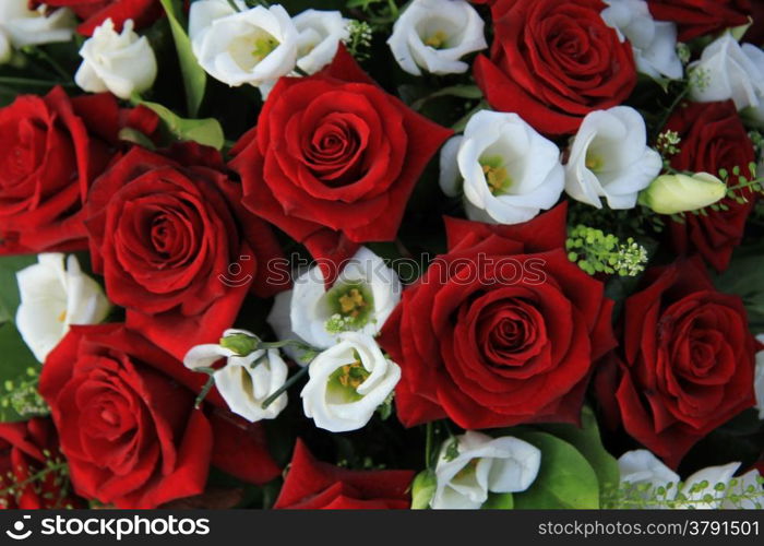 Red roses and white lisianthus in a wedding arrangement