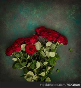 Red roses bouquet on dark stone background. Festive arrangement