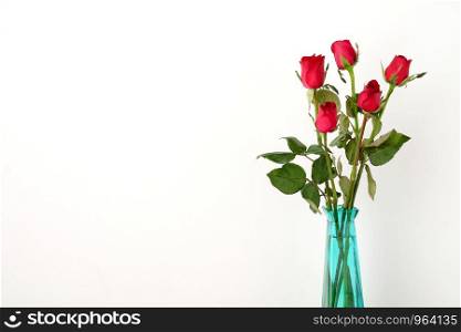 Red roses flower bouquet in green vase on white background, romance love symbol, valentine's day concept, with copy space for text