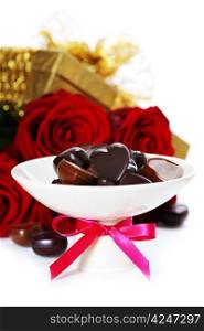 red roses, gifts and chocolate hearts for Valentine&rsquo;s Day