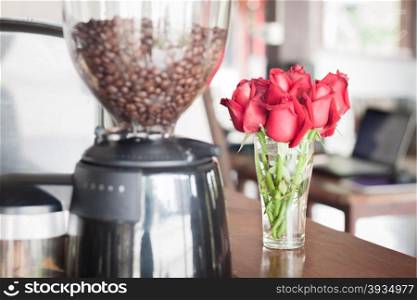 Red roses in coffee shop, stock photo