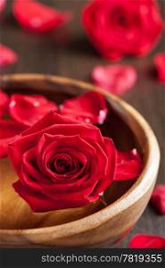 red roses in wooden bowl