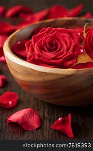 red roses in wooden bowl