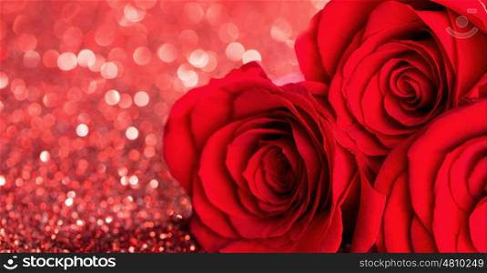 Red roses on glitters. Three beautiful red roses on glitter background