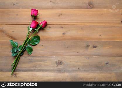 Red roses on vintage wood background, with copy space for text, valentine's day background, love symbol