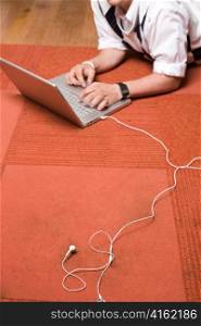 Red Rug, Laptop, White Headphones