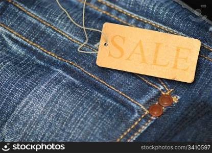 Red Sale Sign With Jeans in Background