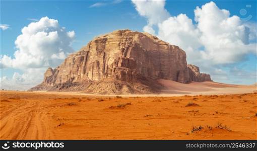 Red sands and huge rock in the middle, Wadi Rum desert, Jordan