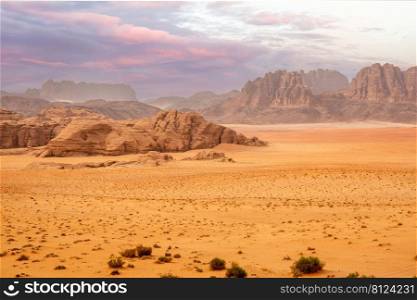 Red sands, mountains, dramatic sky and marthian landscape panorama of Wadi Rum desert, Jordan